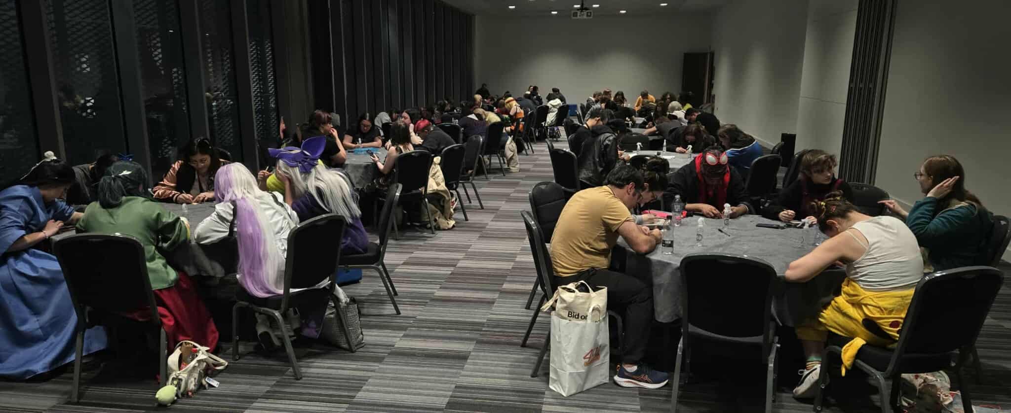 lots of people sat in a conference room having a go at mark making onto the surface of leather